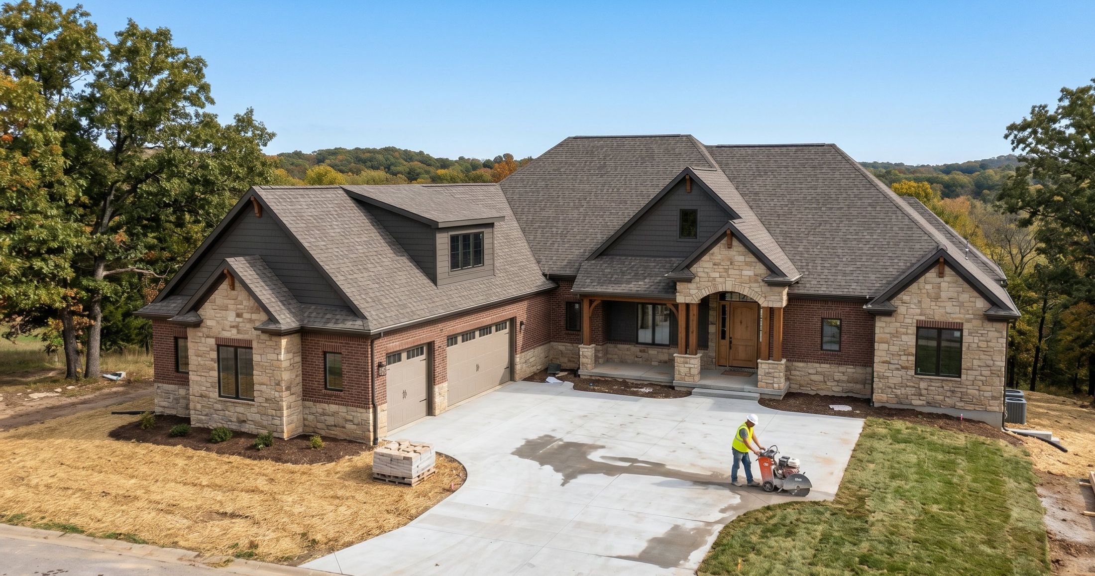 Custom stone-and-brick ranch home under construction in West Central Missouri