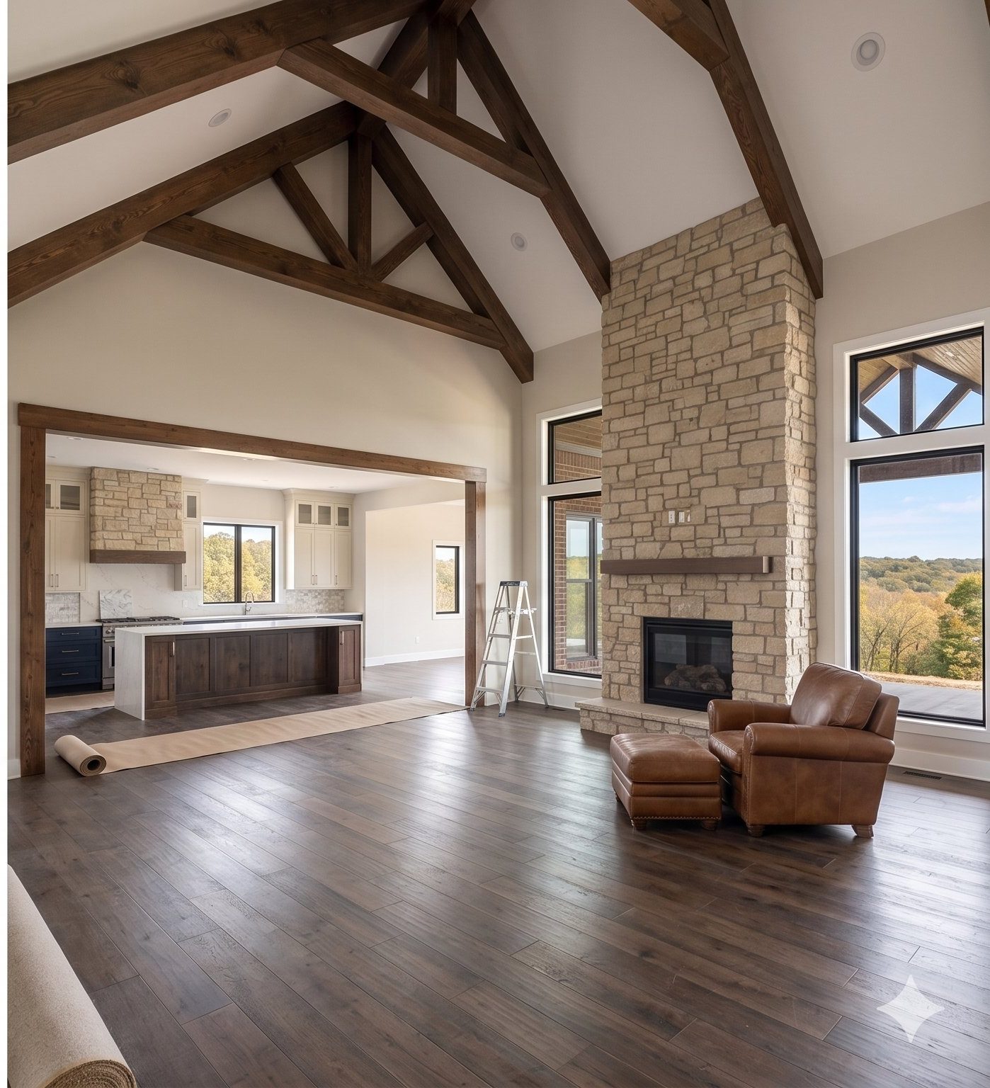 Vaulted great room with exposed timber trusses and stone fireplace